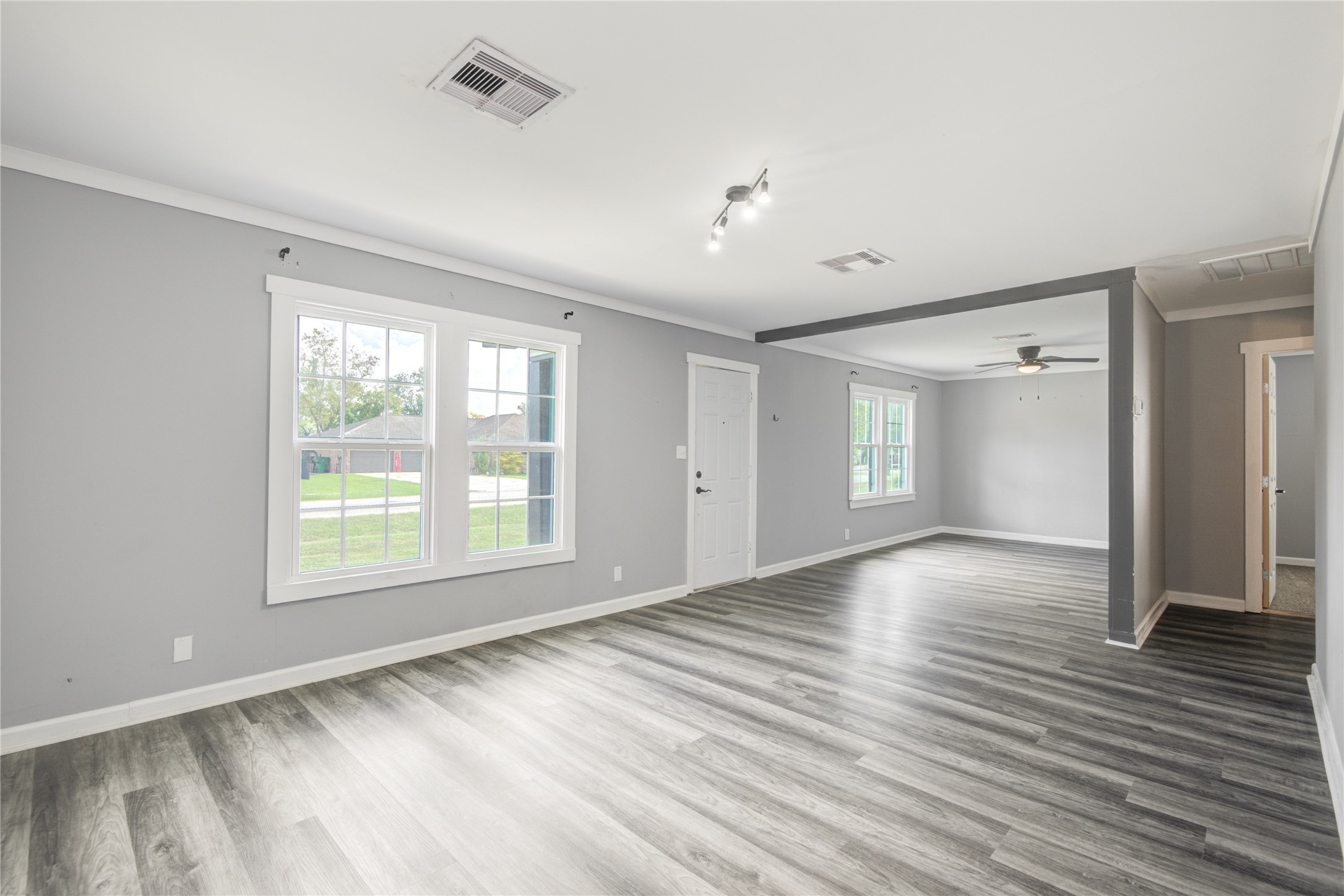 609 Hurst Place Angleton, TX 77515 - Photo 11 of 36 a view of an empty room with wooden floor and a window