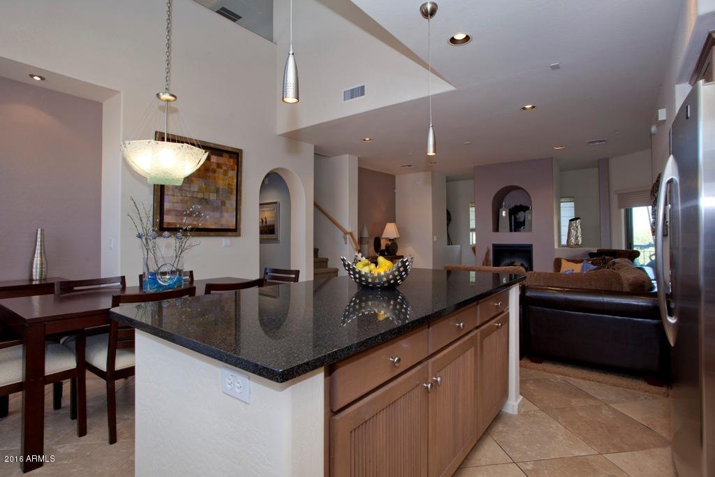 3935 East Rough Rider Road, Unit 1202 Phoenix, AZ 85050 - Photo 13 of 22 Kitchen island looking into Grt Rm