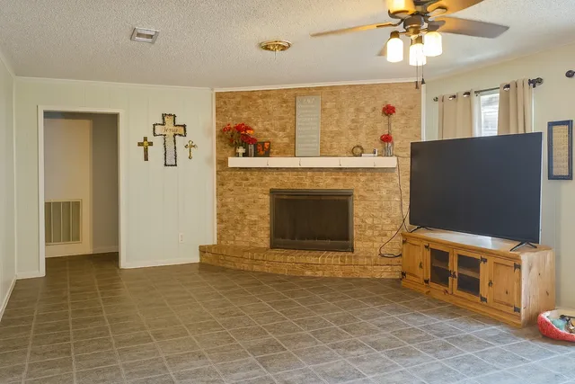 a living room with fireplace furniture and a flat screen tv