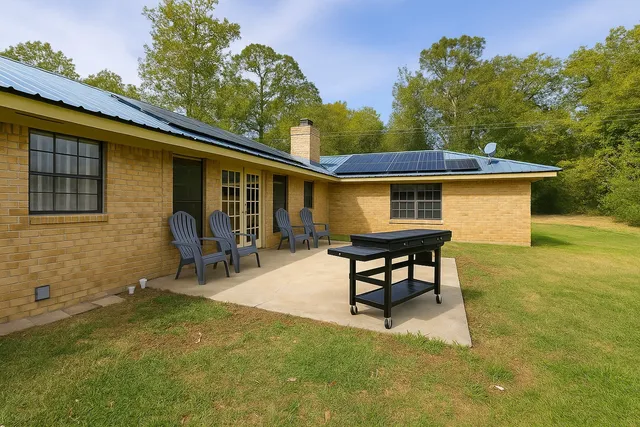 a backyard of a house with table and chairs