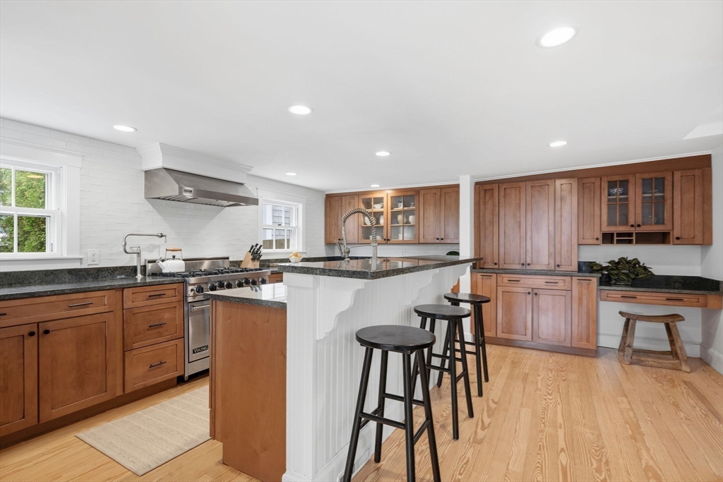 33 Franklin Street Marblehead, MA 01945 - Photo 12 of 42 a kitchen with stainless steel appliances granite countertop refrigerator sink dining table and chairs