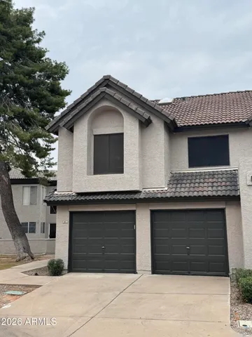 a front view of a house with garage
