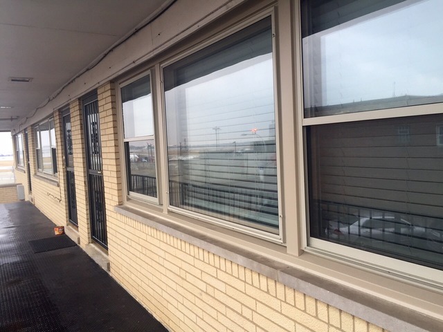 4943 West 63rd Street, Unit 201 Chicago, IL 60638 - Photo 1 of 5 a view of a balcony with wooden floor