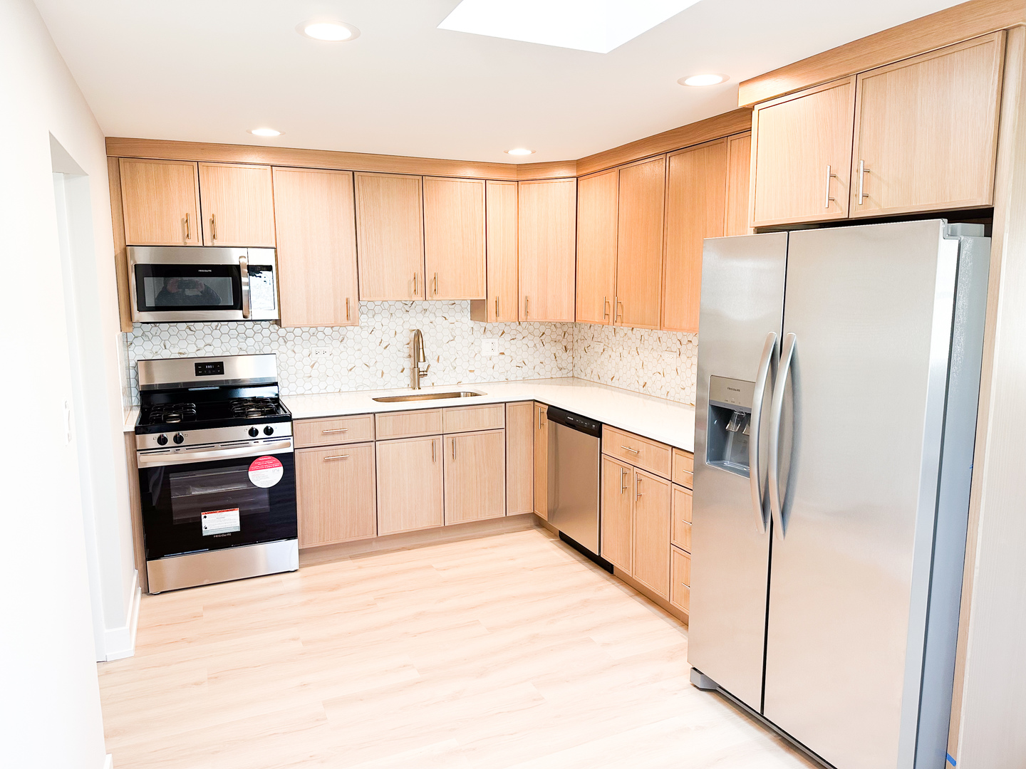4943 West 63rd Street, Unit 201 Chicago, IL 60638 - Photo 2 of 5 a kitchen with stainless steel appliances granite countertop a refrigerator sink and stove