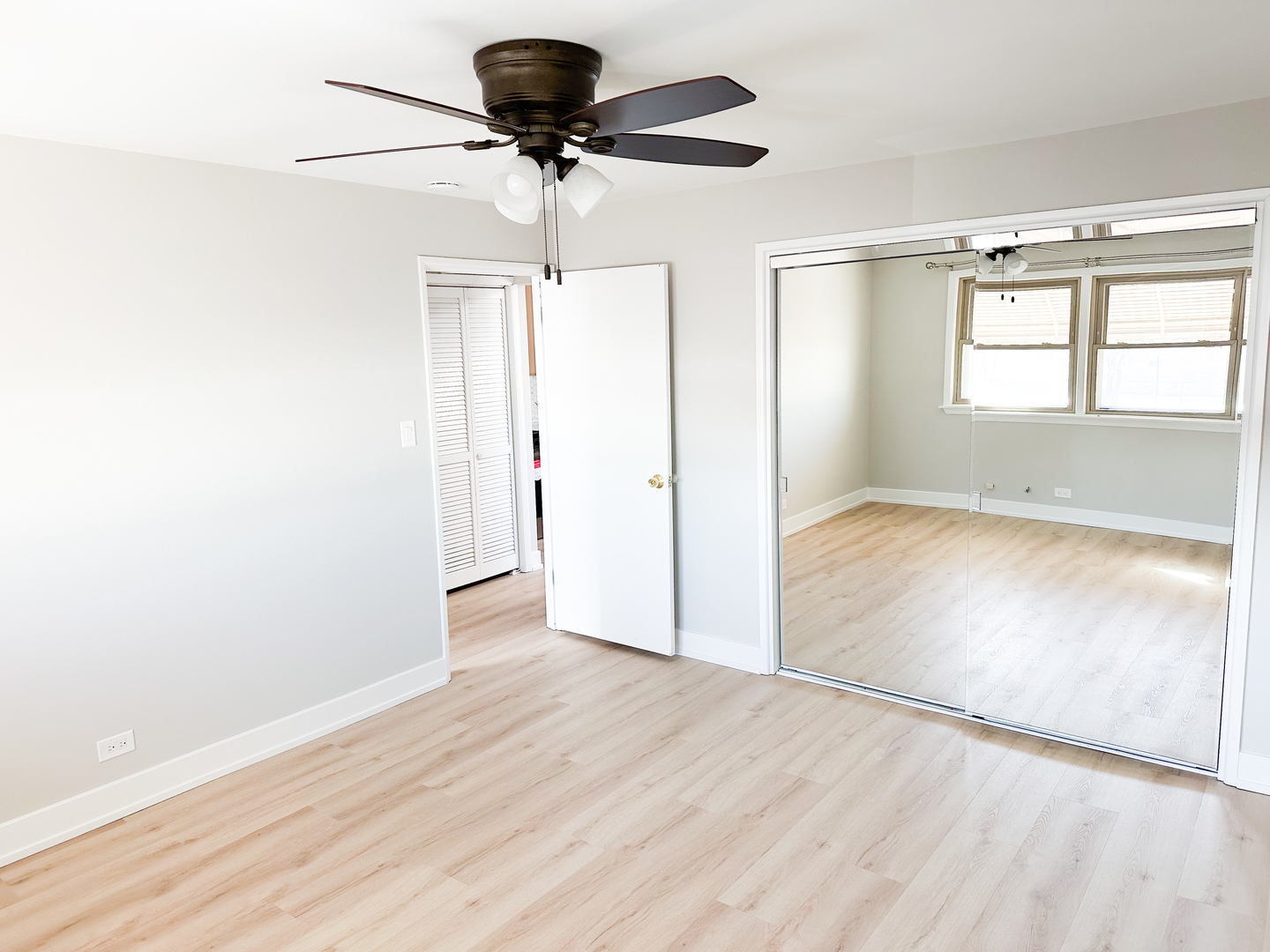 4943 West 63rd Street, Unit 201 Chicago, IL 60638 - Photo 3 of 5 wooden floor in an empty room with a window