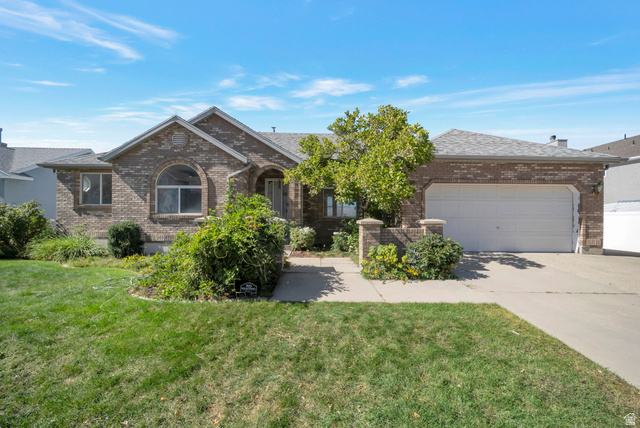 11922 Bluff View Drive Sandy, UT 84092 - Photo 1 of 30 View of front facade featuring an attached garage, concrete driveway, brick siding, and a front lawn