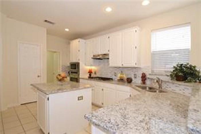 5828 Mossbrook Trail Dallas, TX 75252 - Photo 11 of 25 a kitchen with a sink stove and cabinets
