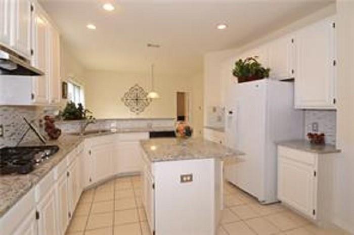 5828 Mossbrook Trail Dallas, TX 75252 - Photo 13 of 25 a kitchen with granite countertop a sink a stove and a refrigerator