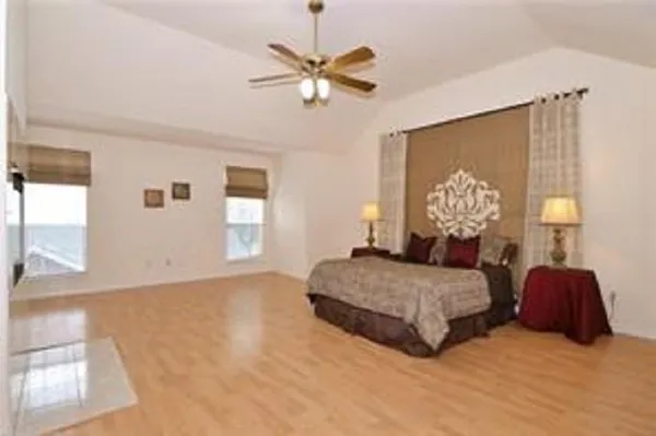 a spacious bedroom with a bed and window