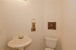 a bathroom with a toilet and a sink
