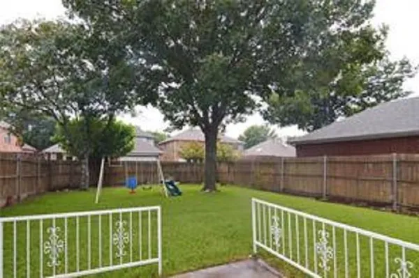 a view of a chair and table in the yard
