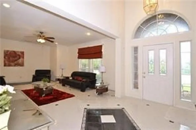 a living room with furniture and a chandelier