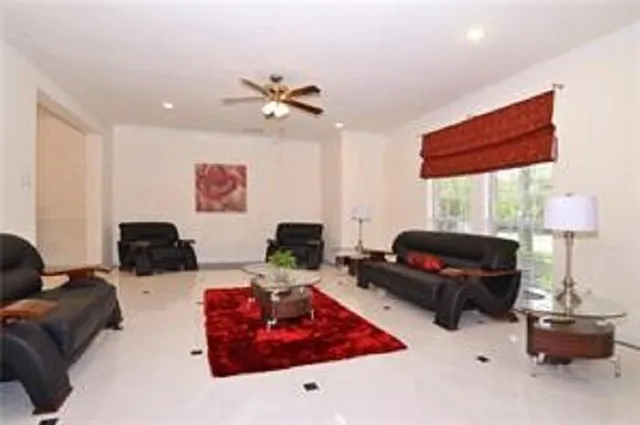 a living room with furniture a bed and a window