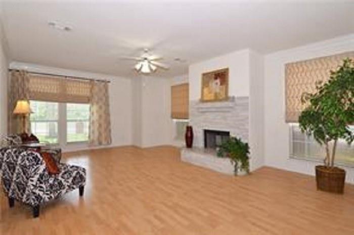 5828 Mossbrook Trail Dallas, TX 75252 - Photo 7 of 25 a living room with furniture and a fireplace