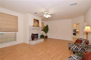 5828 Mossbrook Trail Dallas, TX 75252 - Photo 9 of 25 a bedroom with furniture and a fireplace