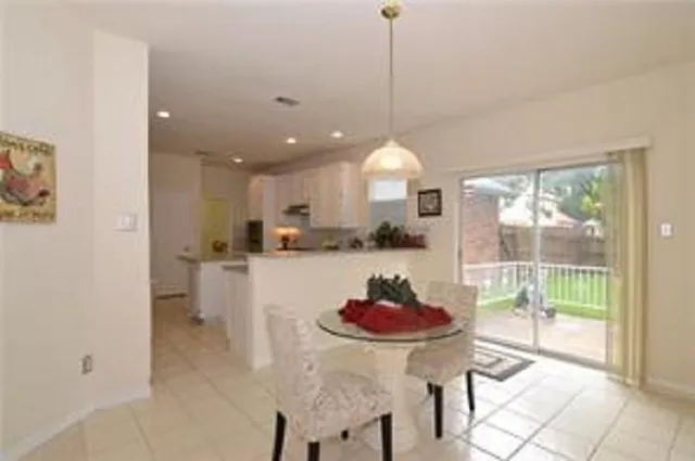 a kitchen with a table and chairs