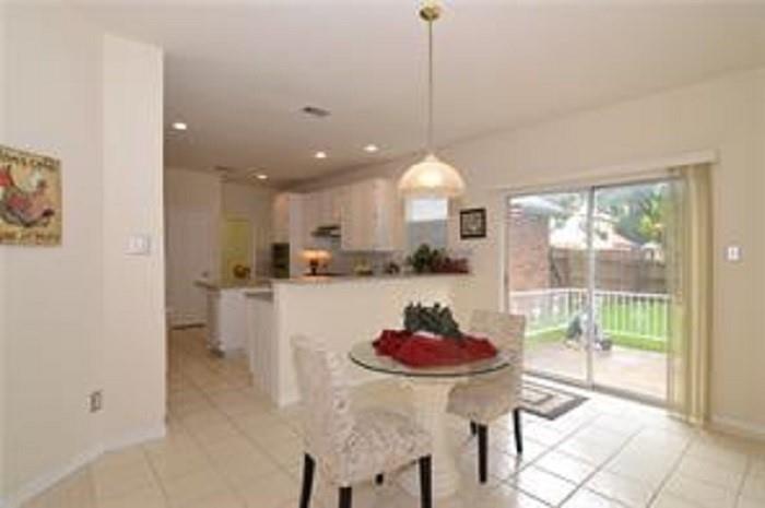 5828 Mossbrook Trail Dallas, TX 75252 - Photo 10 of 25 a kitchen with a table and chairs