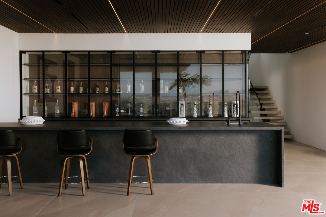 2180 Stradella Road Los Angeles, CA 90077 - Photo 15 of 21 a kitchen with table and chairs