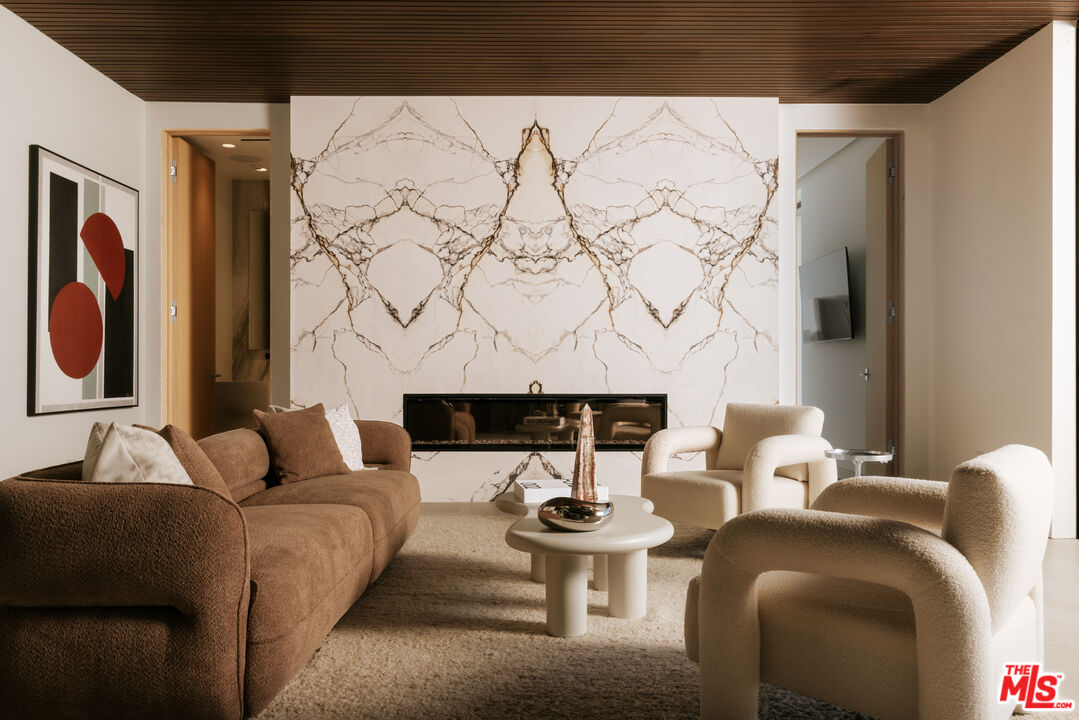 2180 Stradella Road Los Angeles, CA 90077 - Photo 17 of 21 a living room with furniture and wall paintings