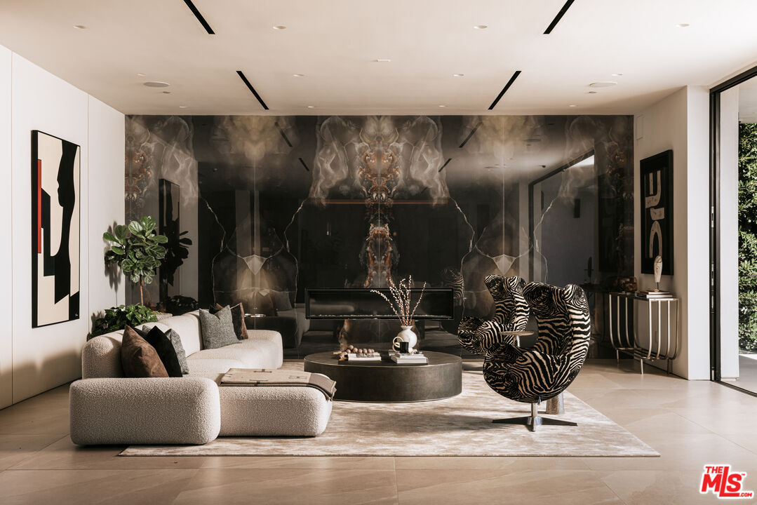 2180 Stradella Road Los Angeles, CA 90077 - Photo 3 of 21 a living room with furniture and a chandelier