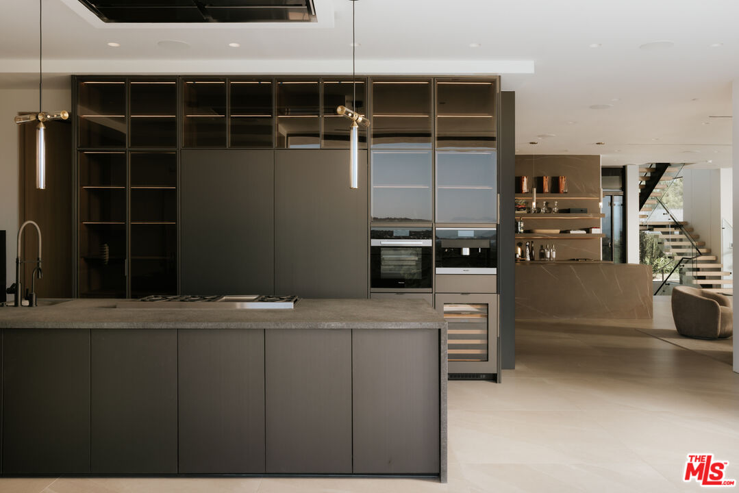 2180 Stradella Road Los Angeles, CA 90077 - Photo 5 of 21 a kitchen with a refrigerator and cabinets