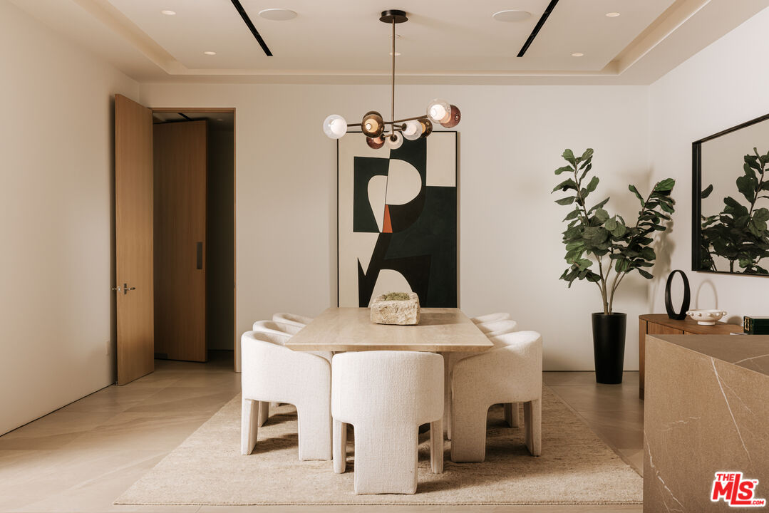 2180 Stradella Road Los Angeles, CA 90077 - Photo 6 of 21 a view of a dining room with a table and chairs