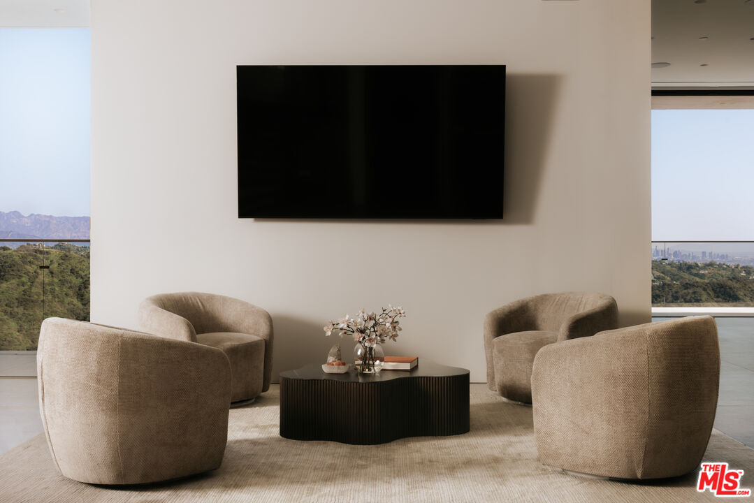 2180 Stradella Road Los Angeles, CA 90077 - Photo 8 of 21 a living room with furniture and a flat screen tv