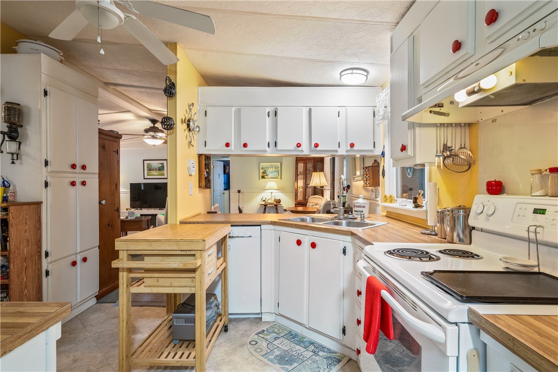 5660 Cypress Drive Yeehaw Junction, FL 34972 - Photo 11 of 36 a kitchen with a sink stove and cabinets