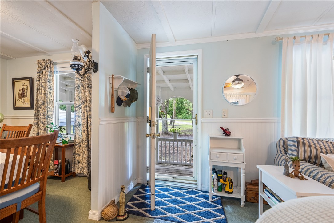 5660 Cypress Drive Yeehaw Junction, FL 34972 - Photo 15 of 36 a living room with furniture a rug and a window