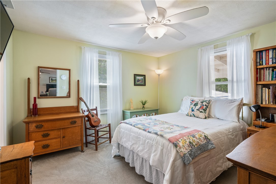 5660 Cypress Drive Yeehaw Junction, FL 34972 - Photo 17 of 36 a bedroom with a bed and a chandelier