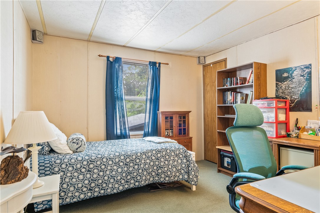 5660 Cypress Drive Yeehaw Junction, FL 34972 - Photo 20 of 36 a bedroom with a bed window and a couch