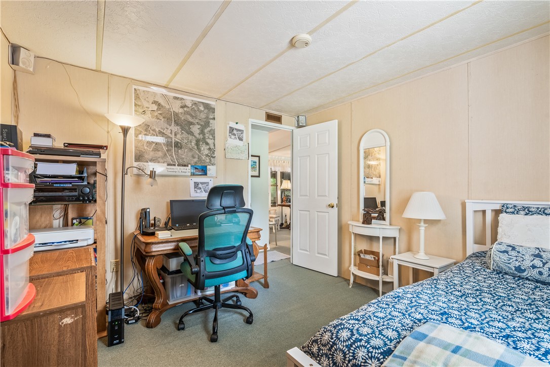 5660 Cypress Drive Yeehaw Junction, FL 34972 - Photo 21 of 36 a bedroom with furniture a bed and a book shelf