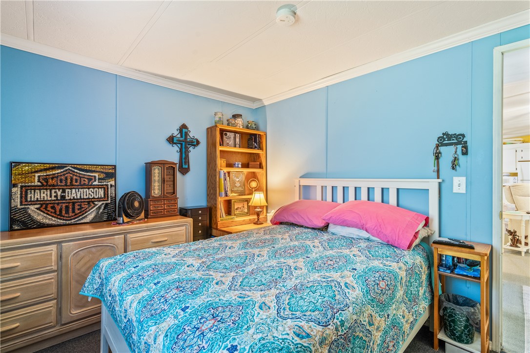 5660 Cypress Drive Yeehaw Junction, FL 34972 - Photo 23 of 36 a bedroom with bed and dresser