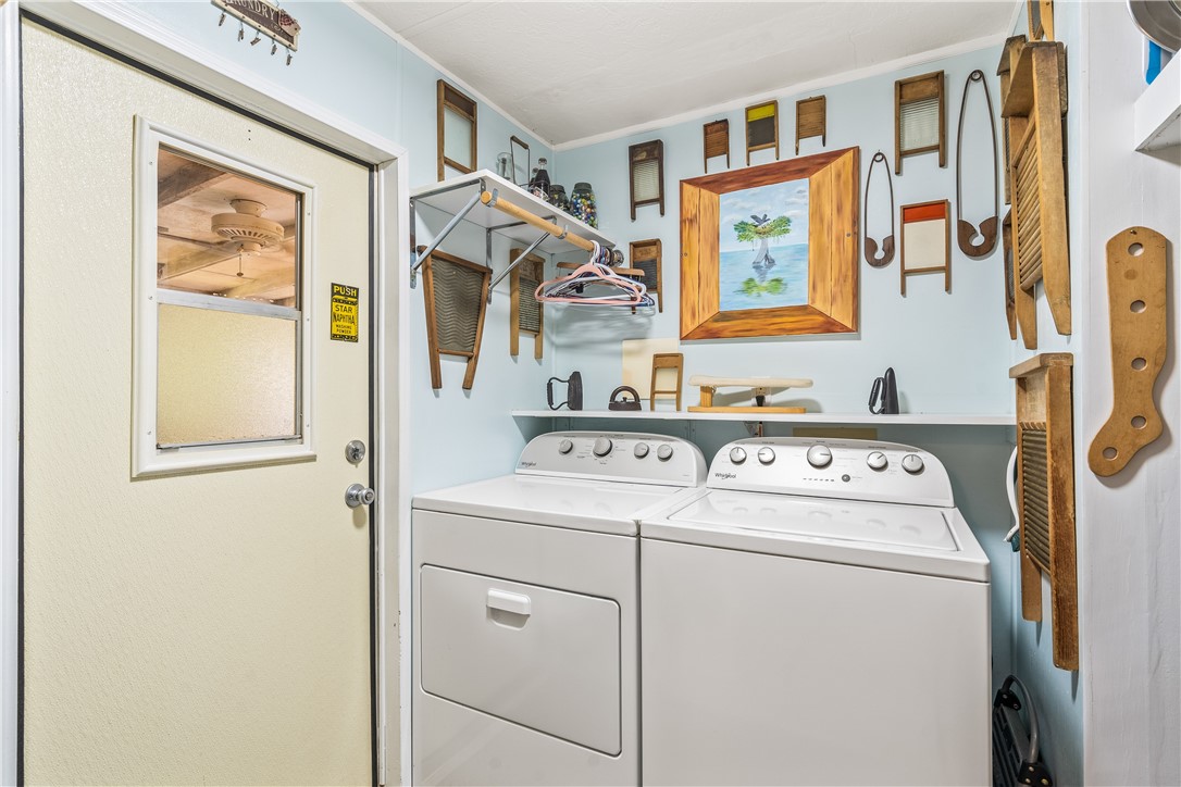 5660 Cypress Drive Yeehaw Junction, FL 34972 - Photo 25 of 36 a utility room with dryer and washer