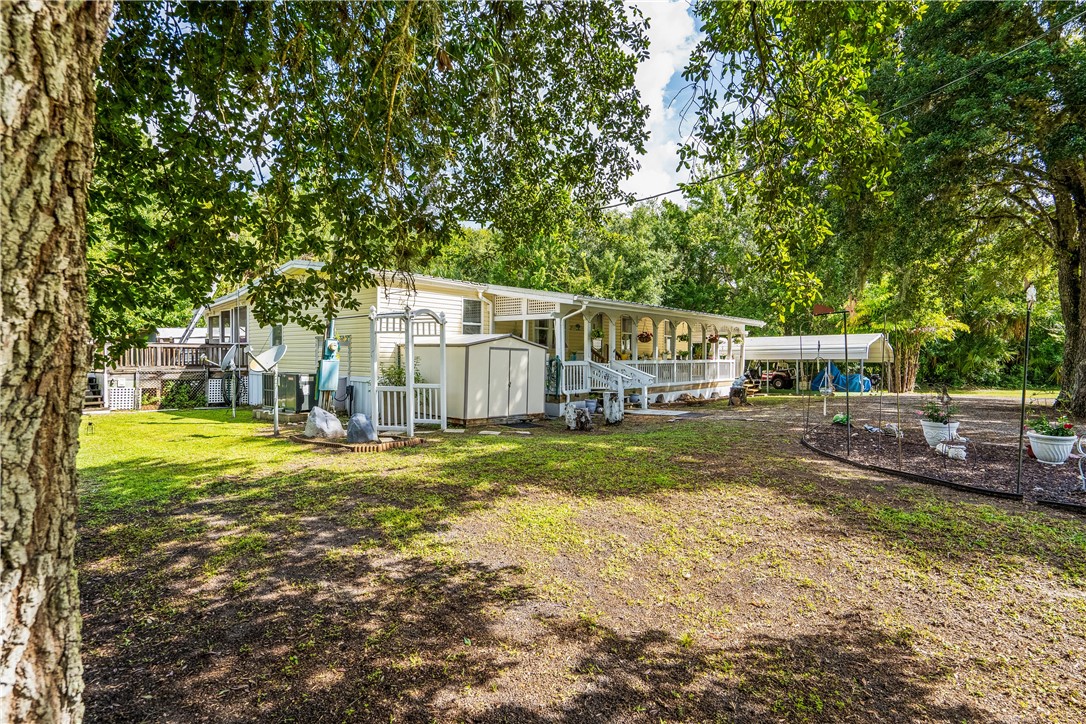 5660 Cypress Drive Yeehaw Junction, FL 34972 - Photo 28 of 36 a view of a house with backyard and sitting area