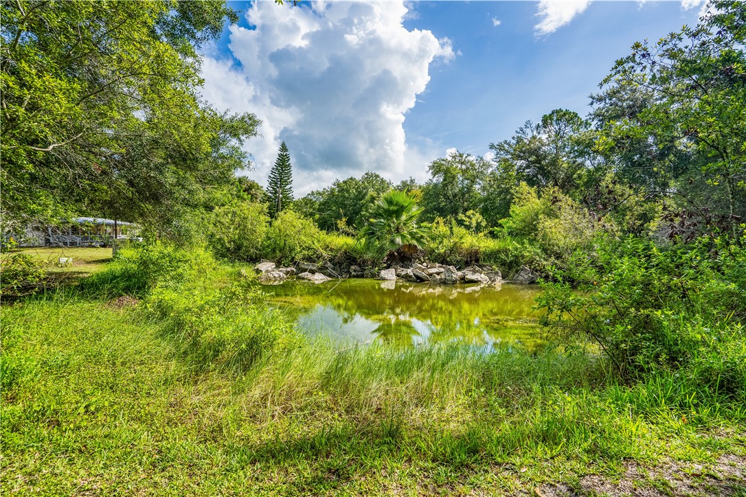 5660 Cypress Drive Yeehaw Junction, FL 34972 - Photo 34 of 36 a view of a lake with a building