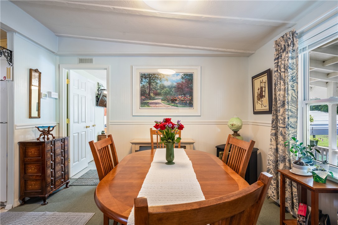 5660 Cypress Drive Yeehaw Junction, FL 34972 - Photo 6 of 36 a view of a dining room with furniture and wooden floor