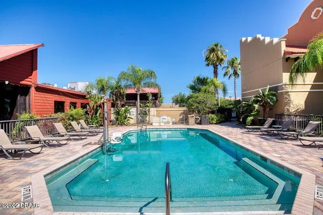 a bedroom with two beds and a lamp