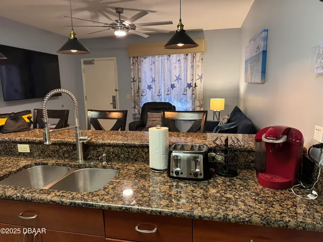 a kitchen with a stove a sink and a microwave