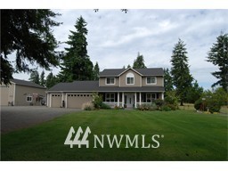 16931 Sheldon Lane Southwest Rochester, WA 98579 - Photo 1 of 1 a front view of a house with a garden