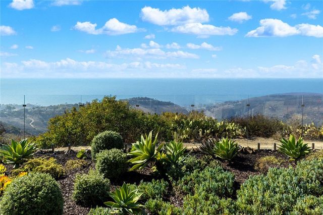 an aerial view of residential houses with outdoor space and seating