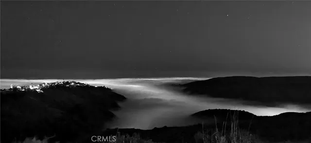 an outdoor living room with patio furniture and a potted plant