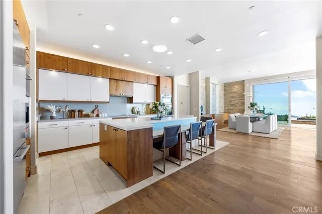 a bedroom with a large bed and a view of living room