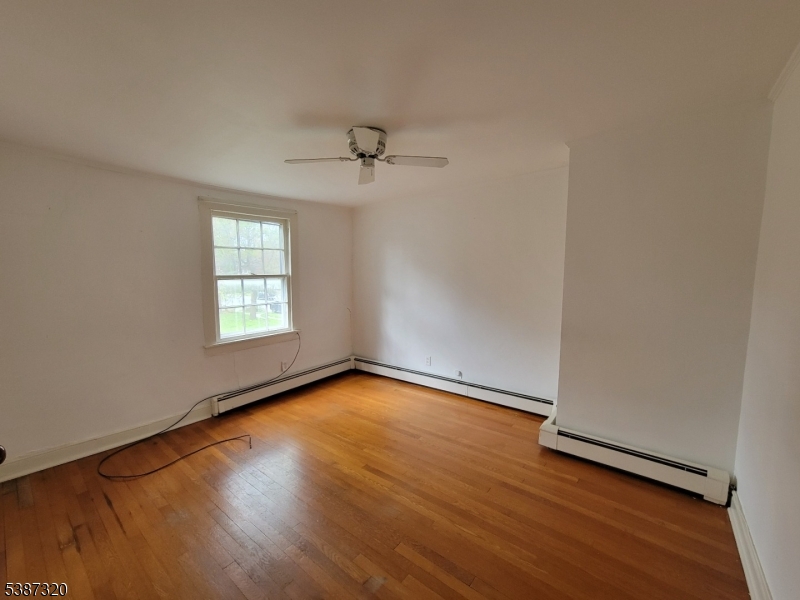 504 3rd Street Belvidere, NJ 07823 - Photo 11 of 13 an empty room with wooden floor and window