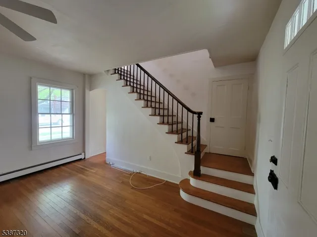 a view of entryway with wooden floor and stairs