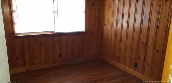 an empty room with wooden floor