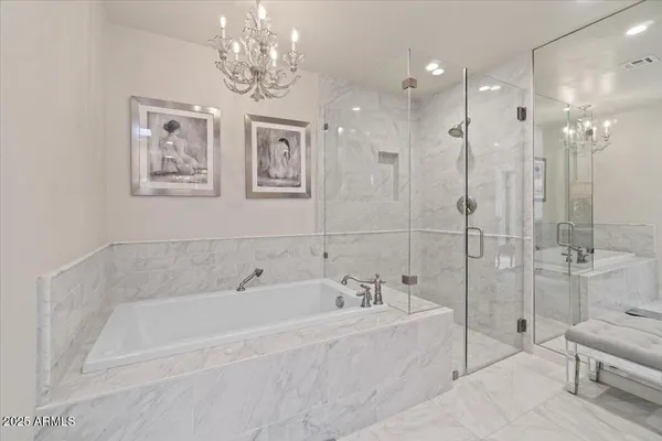 a spacious bathroom with a bathtub and shower