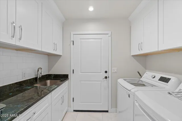a kitchen with a sink cabinets and utility