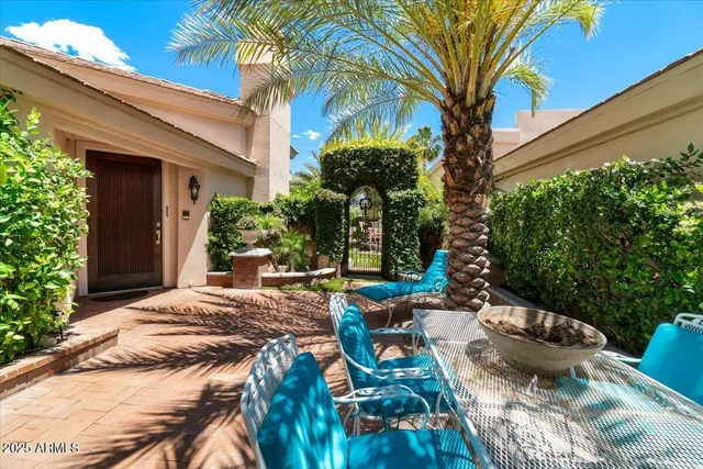 a view of a patio with couches table and chairs and potted plants