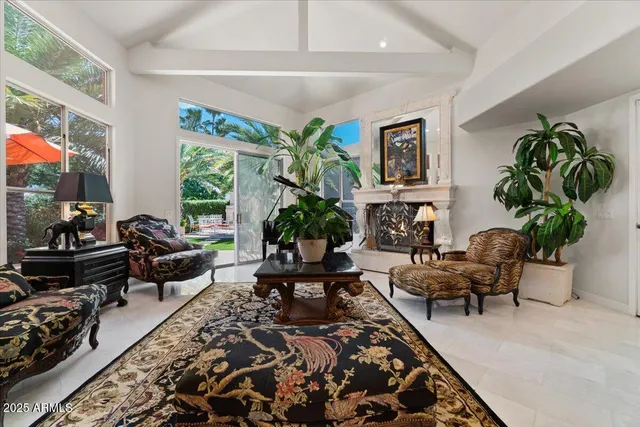 a living room with furniture plant and a large window